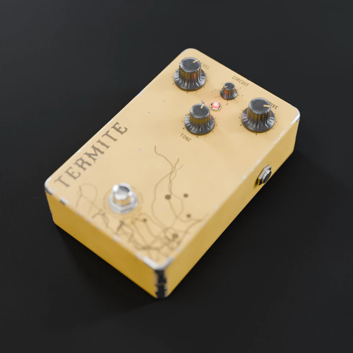 The TERMITE pedal: worn yellow, with tunnel drawings around the footswitch.